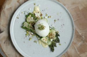 Asparagus and egg on a plate with herbs
