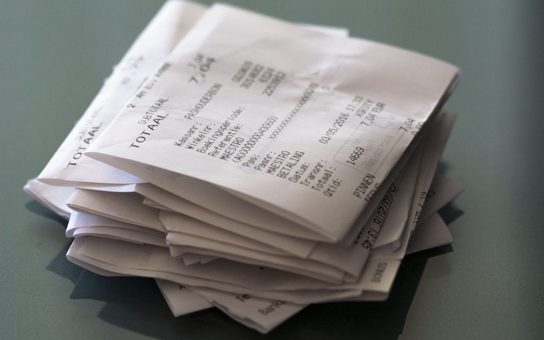 pile of paper receipts on a grey background